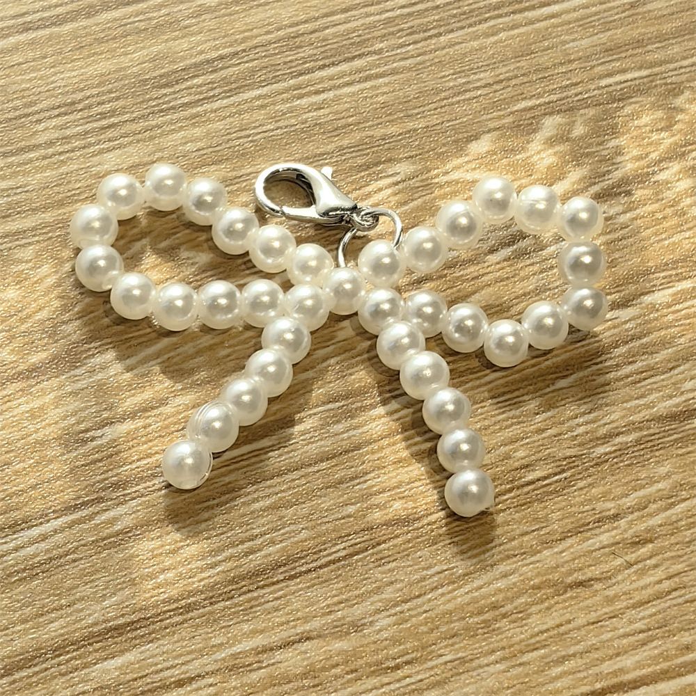 Charm de tenis moñita blanca