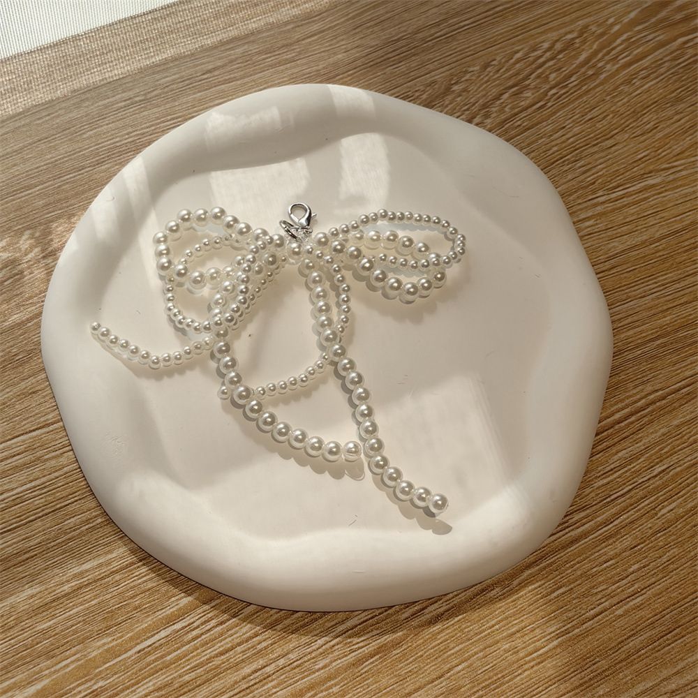Charm de tenis moña blanca
